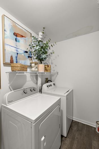A white washing machine and dryer in a laundry room.